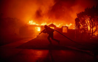 A person escaping a fire during the LA wildfires of 2025.